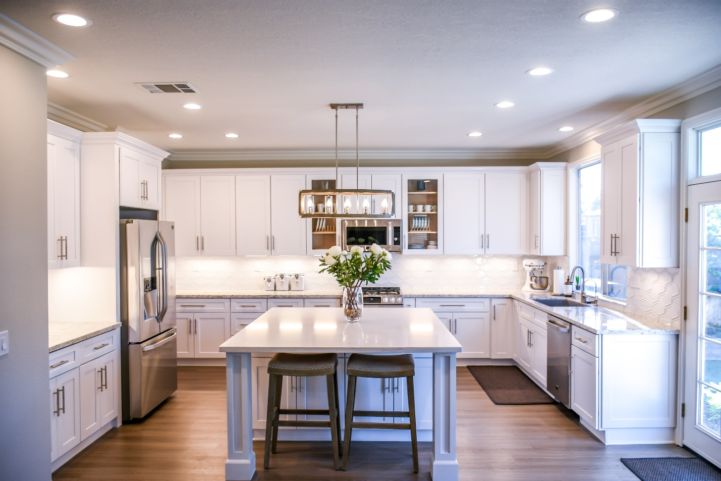 White Cabinets With White Kitchen Island In the Center