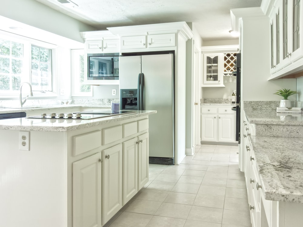 a light grey granite countertops paired with white cabinets