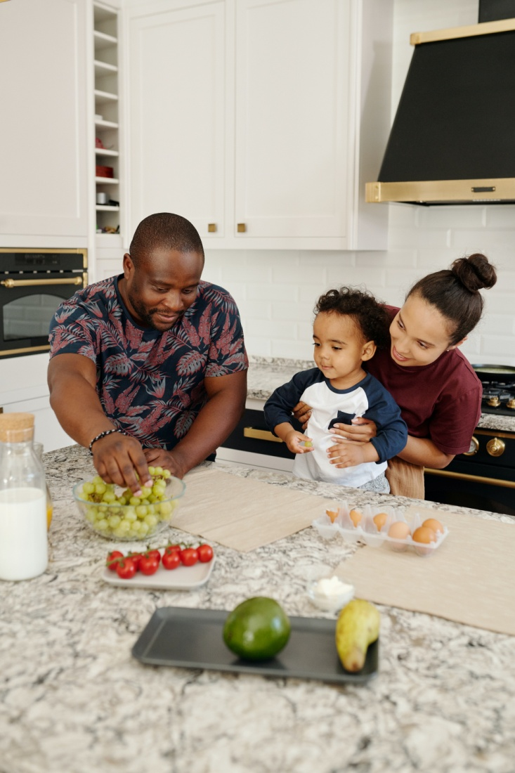 A family enjoying quality time in a kitchen near the laminate countertop
