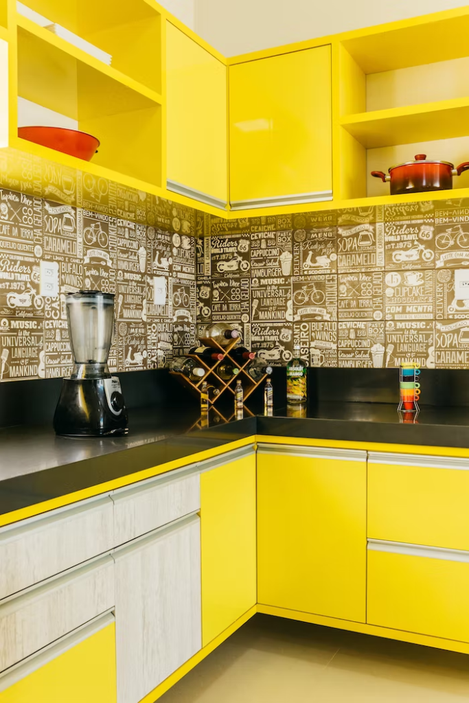 yellow and a pale wooden cabinet theme with black countertops